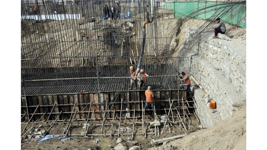 Afghan laborers work on a bridge project funded by the government, in Kabul, Afghanistan. Rebuilding war-torn Afghanistan has cost thousands of lives, according to a new U.S. government report.