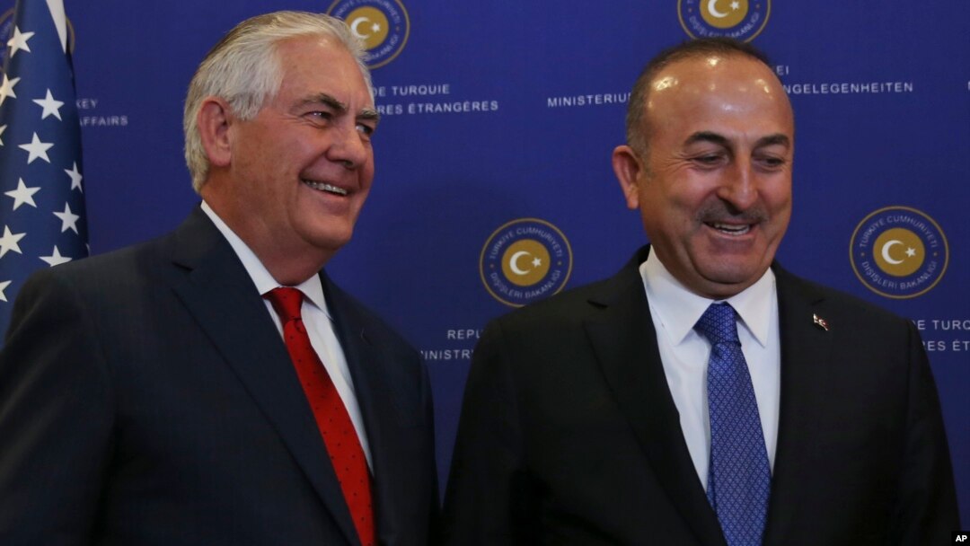 U.S. Secretary of State Rex Tillerson, left, and Turkey's Foreign Minister Mevlut Cavusoglu stop for photographers prior to their meeting in Ankara, March 30, 2017.