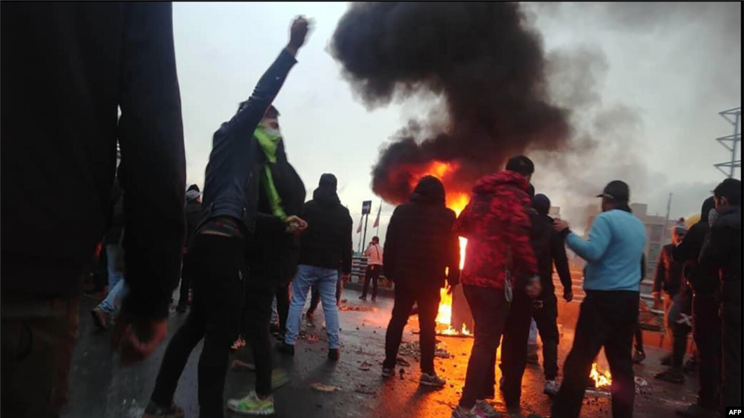 FILE - Anti-government protesters take to the streets in Iran, November 2019.