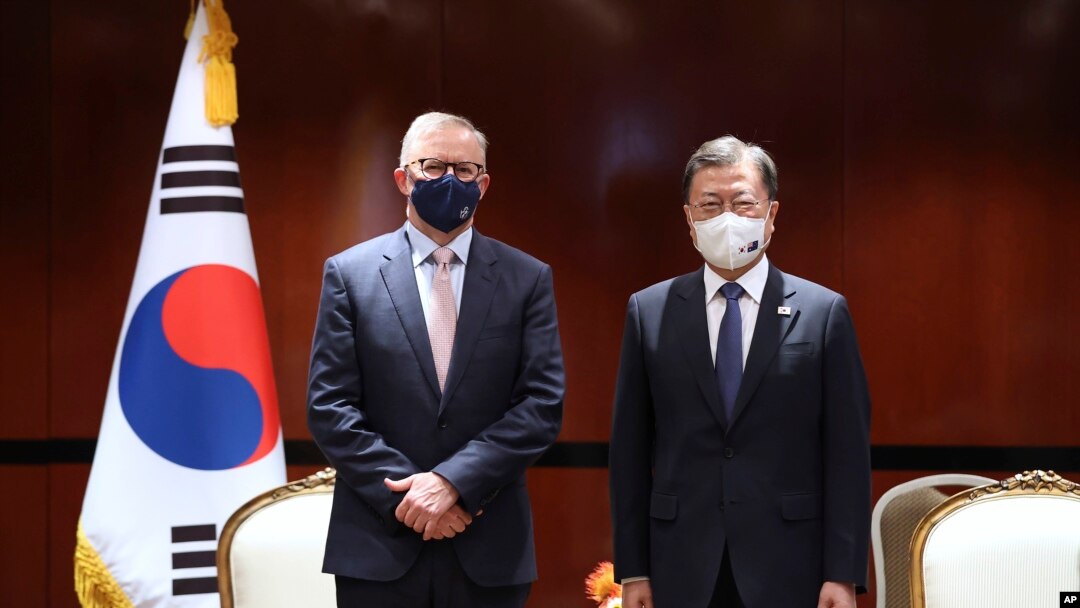 South Korean President Moon Jae-in, right, poses for a photo with Australian opposition Labor Party leader Anthony Albanese in Sydney, Dec. 14, 2021.