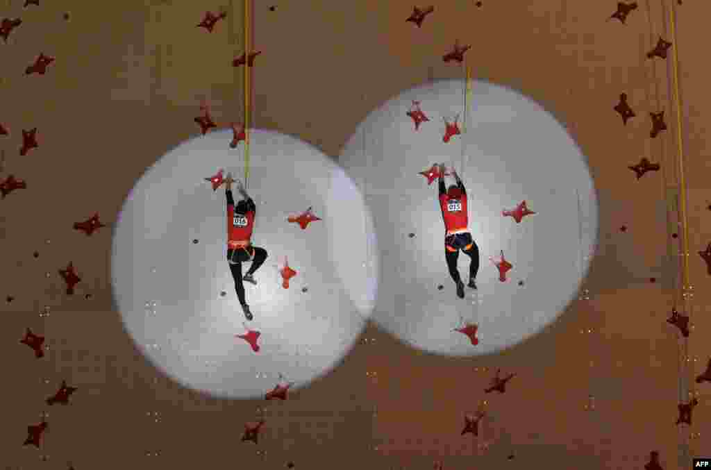 Indonesia's Susanti Rahayu Aries (L) competes against Indonesia's Puji Lestari (R) during the final of the women's speed sport climbing event at the 2018 Asian Games in Palembang, Indonesia.