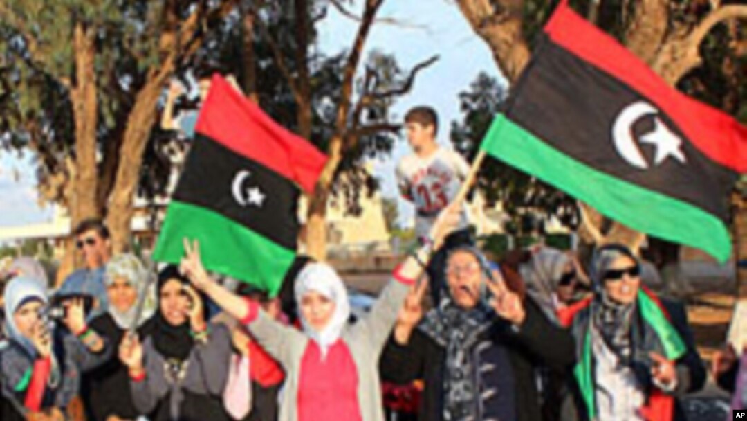 Libyans greet rebel fighters upon their arrival in Benghazi from Sirte on October 22, 2011.