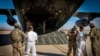 The first U.S. military aircraft to carry detained migrants to Guantanamo Bay is boarded from an unspecified location in the U.S.