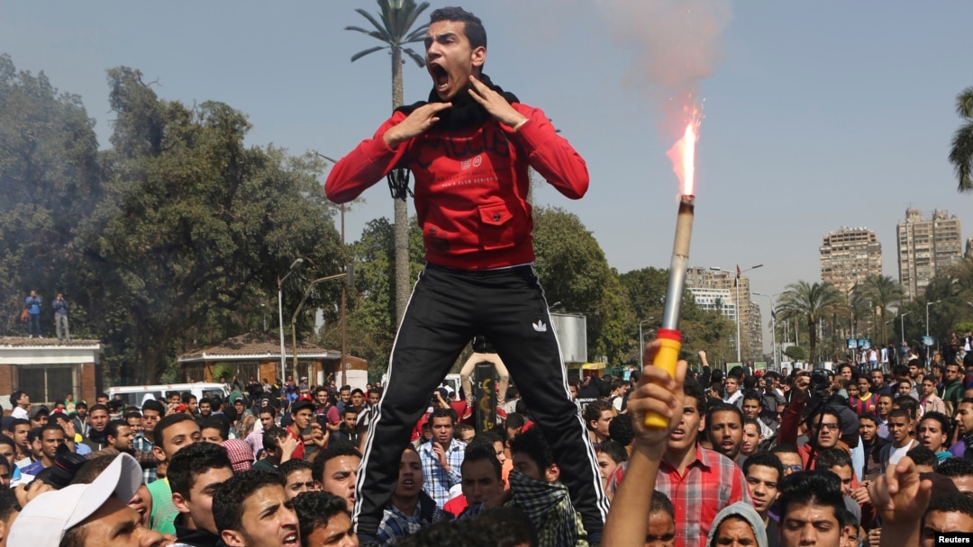 Students who are supporters of the Muslim Brotherhood and ousted President Mohamed Morsi shout slogans in front of Cairo University, March 26, 2014.