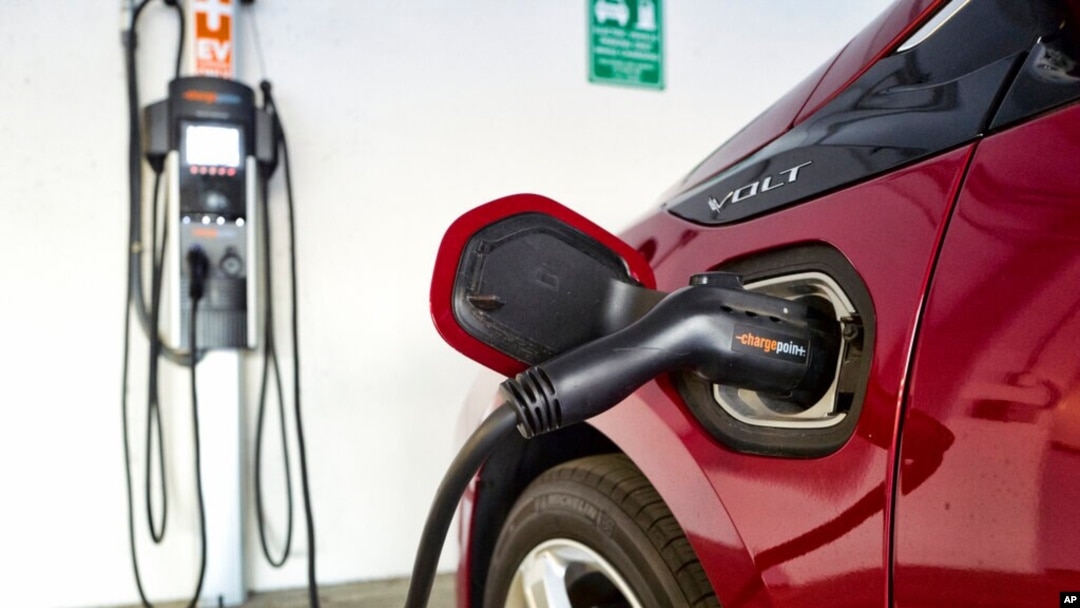 FILE - A Chevrolet Volt hybrid car is hooked up at a ChargePoint charging station at a parking garage in Los Angeles, Oct. 17, 2018. 