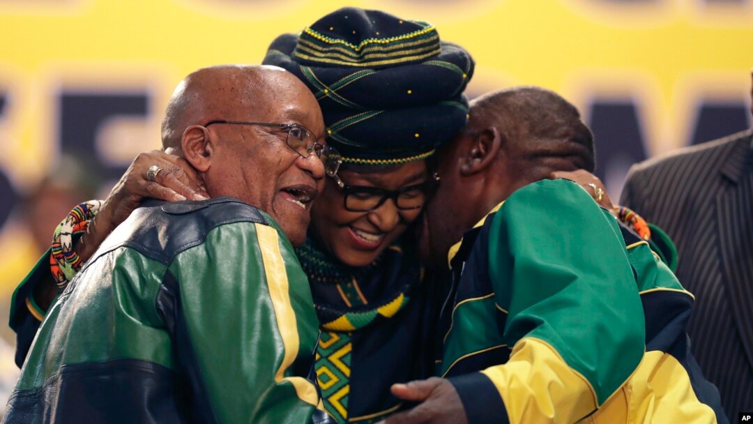 Winnie Madikizela-Mandela, centre, hugs front runner and Deputy President, Cyril Ramaphosa, right, and President Jacob Zuma, left, at the start of the ruling African National Congress (ANC) elective conference in Johannesburg, South Africa, Dec. 16 2017. 