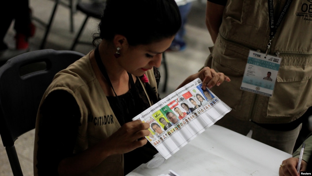 A woman takes part in a hand count of some of the votes cast in Honduras' recent presidential election in Tegucigalpa, Dec. 7, 2017.