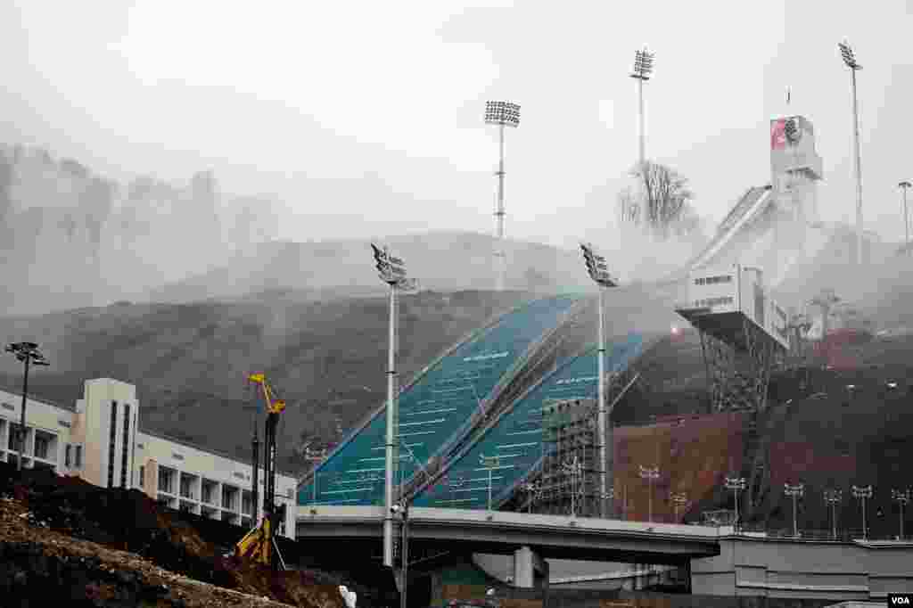 The Olympic ski jump rises from the mountain mists above Sochi, Russia, March 17, 2013. (V. Undritz/VOA)
