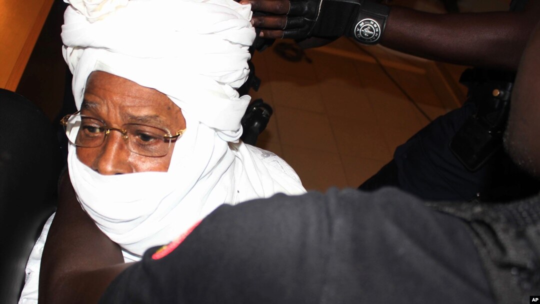 Security personnel surround former Chadian dictator Hissene Habre inside the court, in Dakar, Senegal, July 20, 2015. 