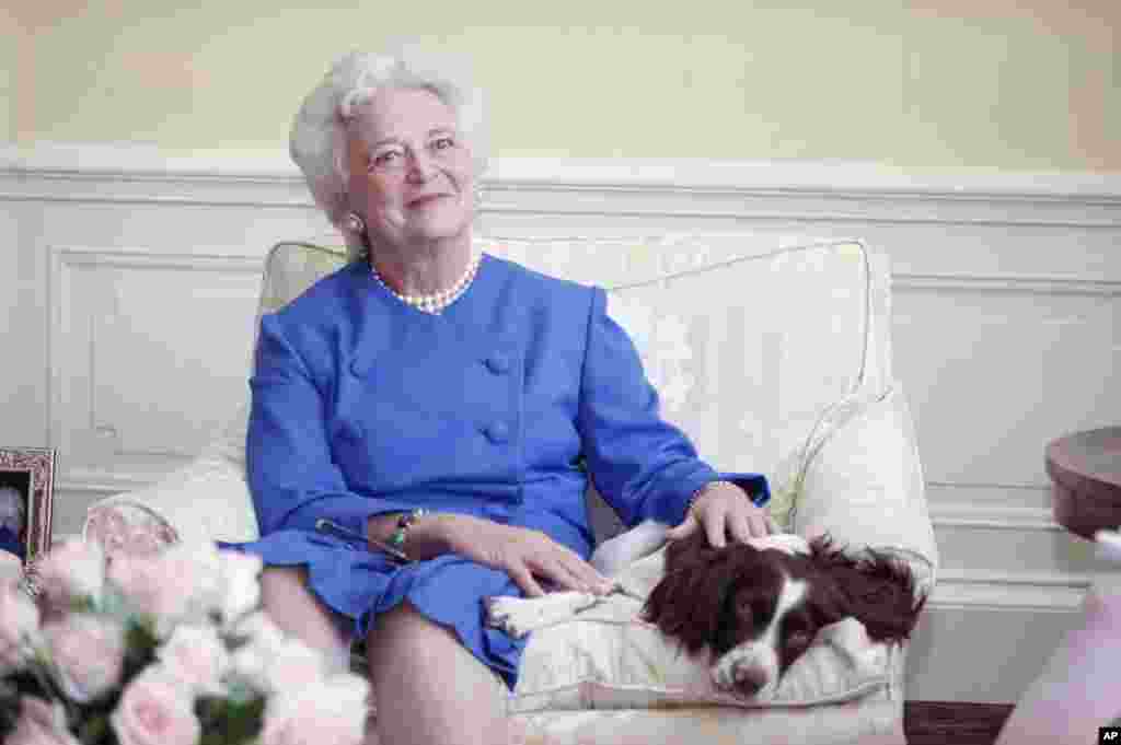 First lady Barbara Bush poses with her dog Millie in 1990.