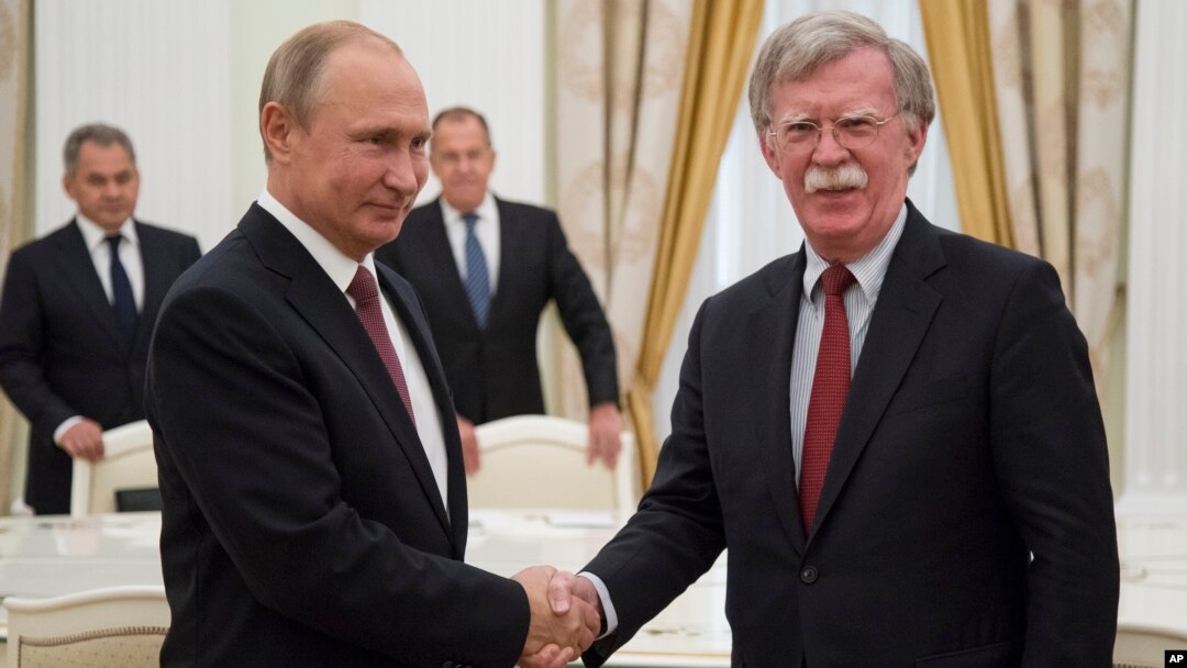 Russian President Vladimir Putin, left, shakes hands with U.S. National security adviser John Bolton during their meeting in the Kremlin in Moscow, Russia, June 27, 2018. 