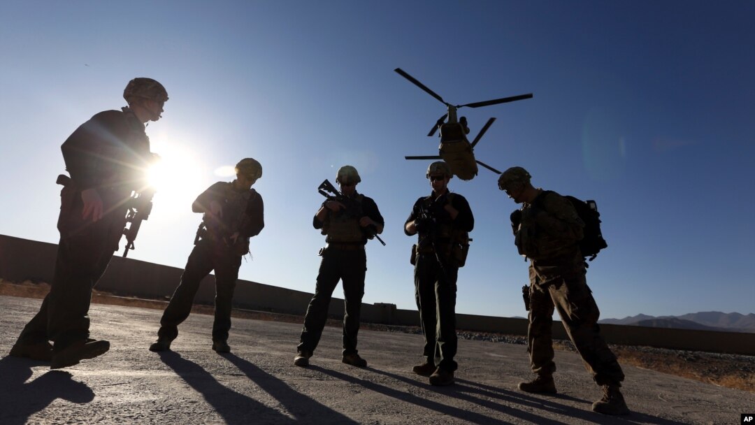 FILE - American soldiers wait on the tarmac in Logar province, Afghanistan in this Nov. 30, 2017 photo. (AP Photo)