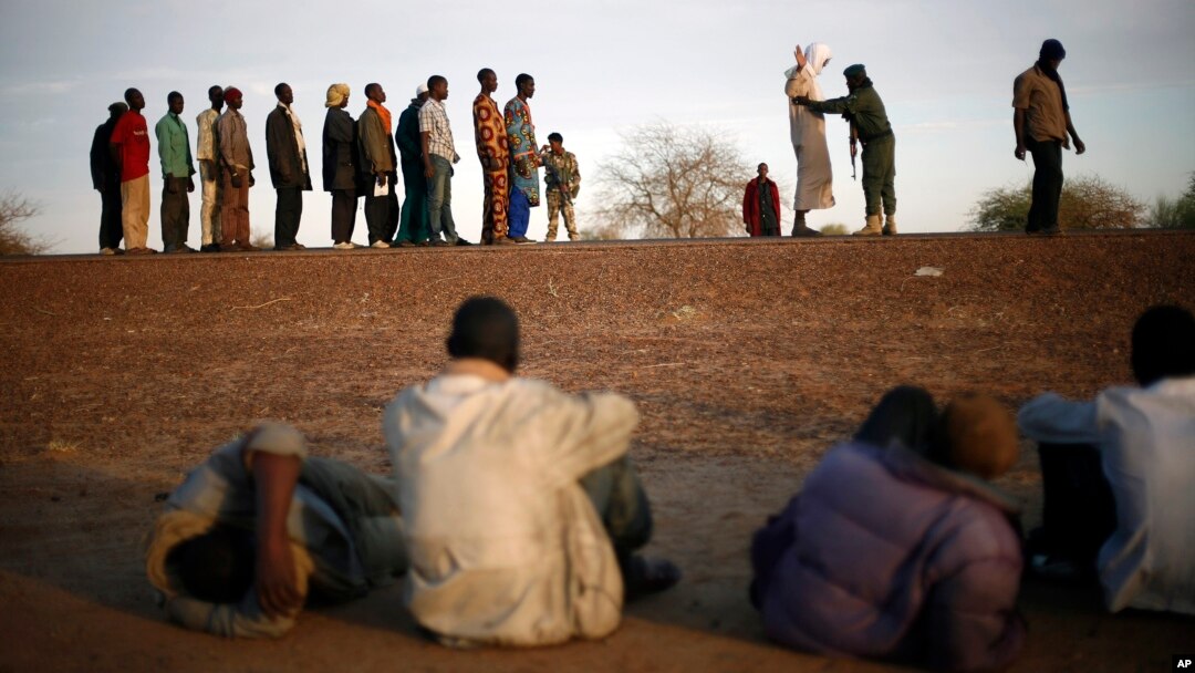 Travelers driving from Niamey, Niger, lining up to be searched at the entrance of Gao, northern Mali, Feb. 12, 2013.