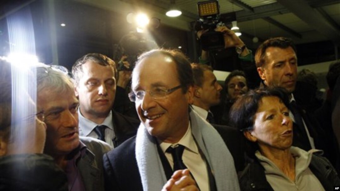 Socialist candidate Francois Hollande, center, arrives at Brive airport in Brive, Central France, after the first round of the presidential election, April 22, 2012.