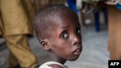 A boy suffering from severe acute malnutrition sits at one of the UNICEF nutrition clinics, in the Muna informal settlement, which houses nearly 16,000 IDPs (internally displaced people) in the outskirts of Maiduguri capital of Borno State, northeastern Nigeria.
