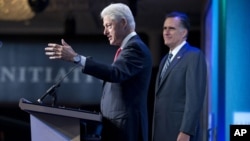El expresidente Bill Clinton presenta a Mitt Romney, quien este martes habló ante el foro Iniciativa Global Clinton, en Nueva York.