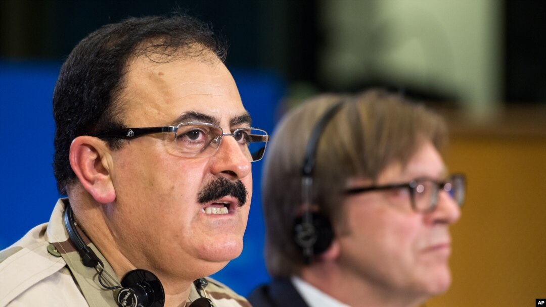 FILE - Chief of Staff of the Free Syrian Army Gen. Salim Idris addresses the media after he discussed the situation in Syria with the leader of the Group of the Alliance of Liberals and Democrats for Europe Guy Verhofstadt, right, at the European Parliament in Brussels, March 6, 2013. 