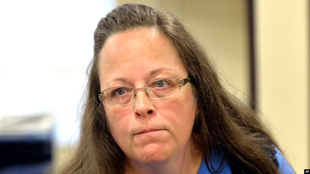 Rowan County Clerk Kim Davis listens to a customer following her office's refusal to issue marriage licenses at the Rowan County Courthouse in Morehead, Ky., Sept. 1, 2015. 