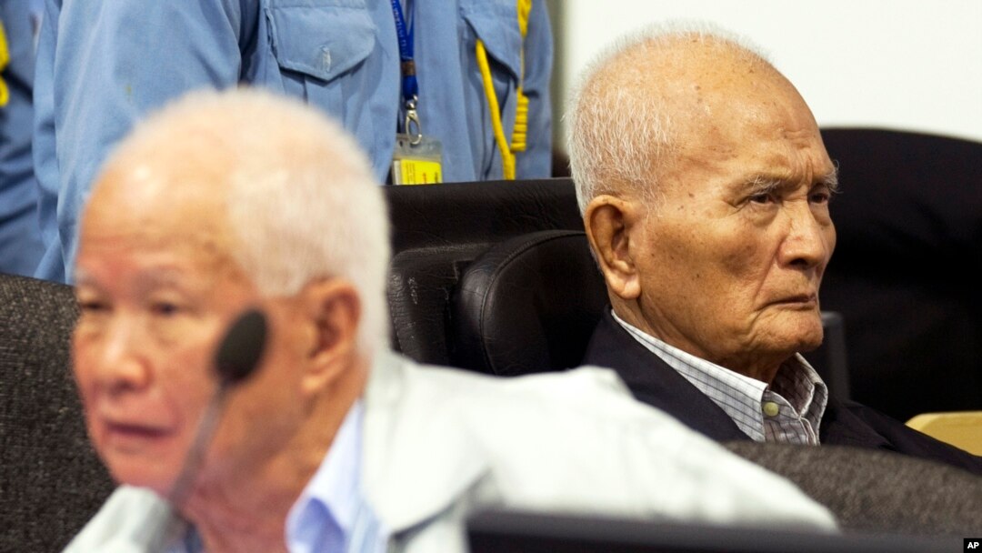 FILE - Khieu Samphan, left, former Khmer Rouge head of state, and Nuon Chea, Khmer Rouge's chief ideologist and No. 2 leader, before closing statements, U.N.- backed war crimes tribunal, Phnom Penh, Oct. 31, 2013.
