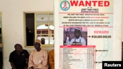 A poster advertising for the search of Boko Haram leader Abubakar Shekau is pasted on a wall in Baga village on the outskirts of Maiduguri, in the north-eastern state of Borno, Nigeria, May 13, 2013. 