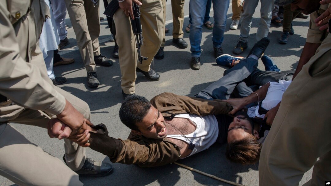 Indian policemen detain Kashmiri Shiite Muslims for participating in a religious procession in central Srinagar, Indian controlled Kashmir, Wednesday, Sept. 19, 2018.