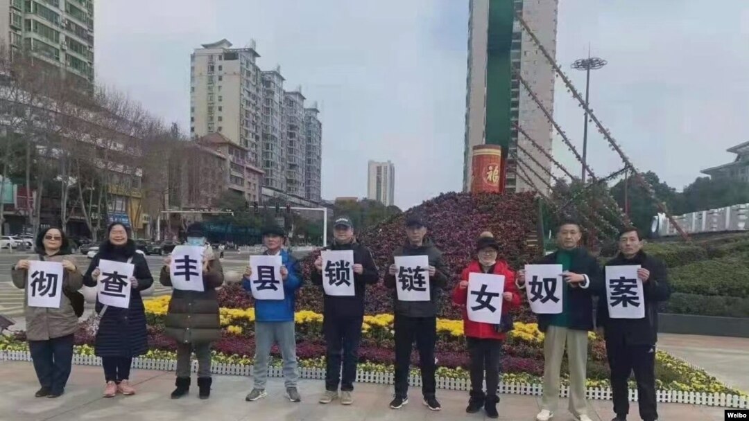 中國民眾走上湖南嶽陽街頭舉牌呼籲徹查鎖鏈女奴案。（取自推特照片）