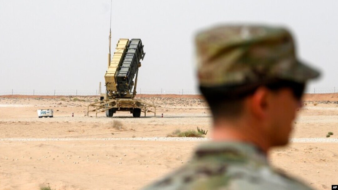 FILE - A member of the U.S. Air Force stands near a Patriot missile battery at the Prince Sultan air base in al-Kharj, central Saudi Arabia, Feb. 20, 2020.