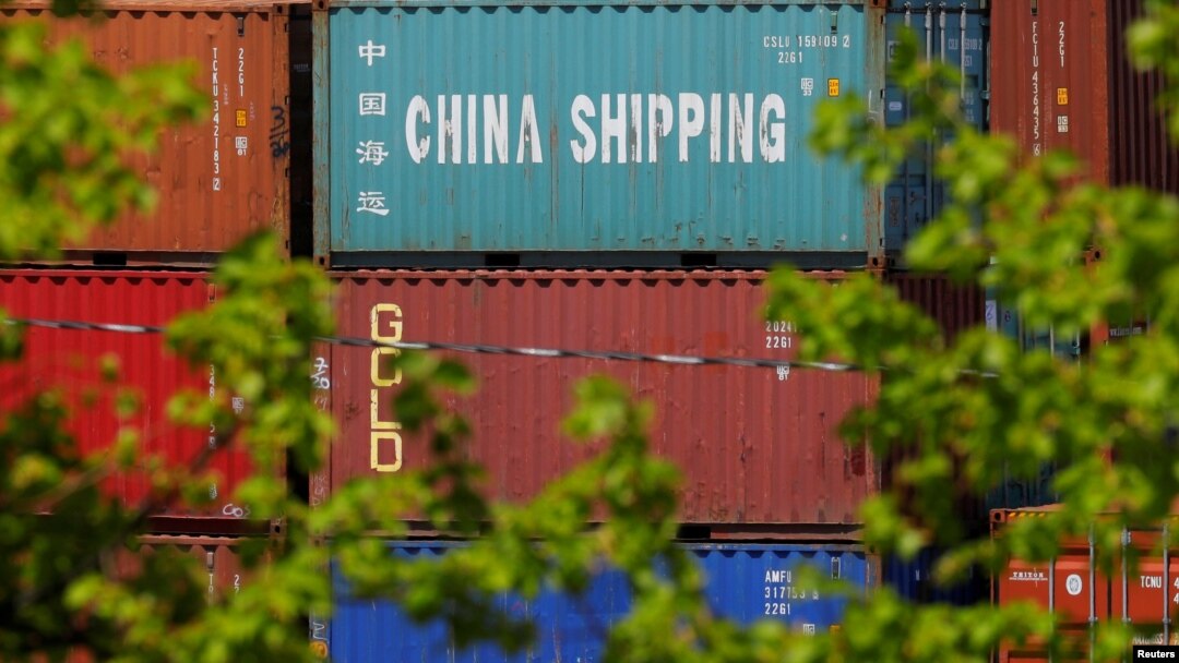 FILE - Shipping containers, including one labeled "China Shipping," are stacked at the Paul W. Conley Container Terminal in Boston, Mass., May 9, 2018. 