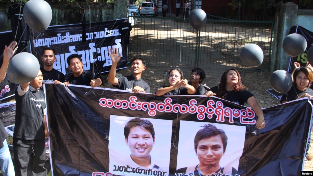 FILE - Journalists take part in a protest outside the court where Reuters journalists Wa Lone and Kyaw Soe Oo attend a hearing in Yangon, Myanmar, Jan. 10, 2018.