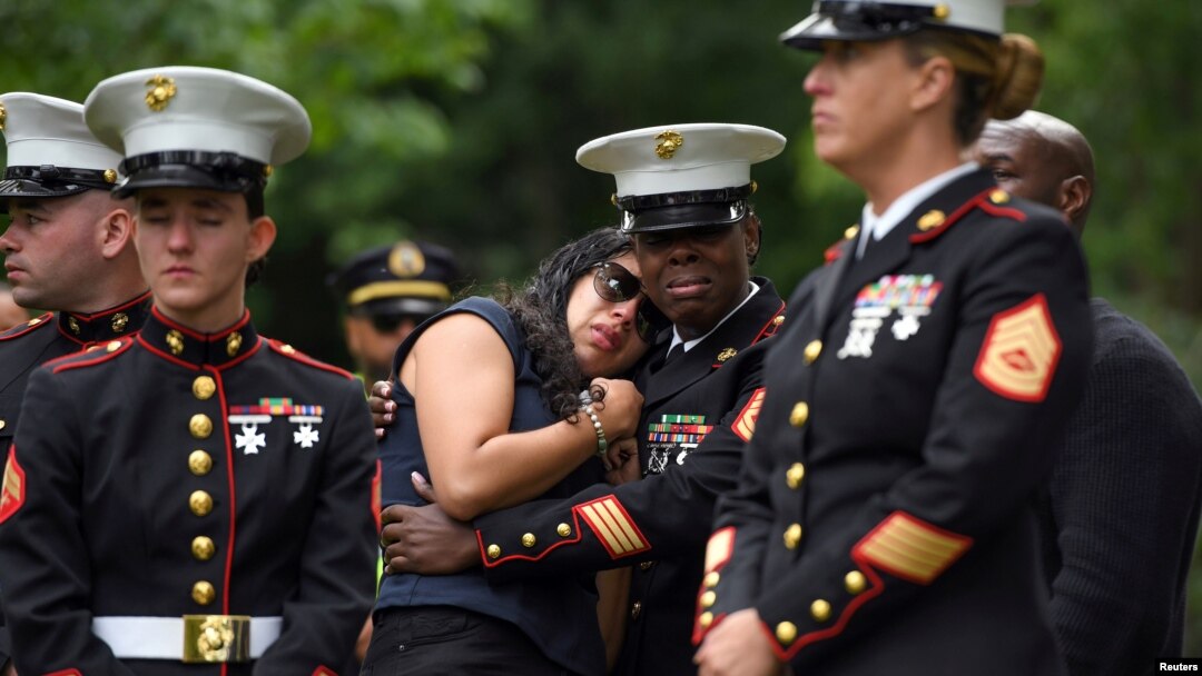 Fellow Marines who served in Bahrain with Marine Corps Sgt. Johanny Rosario Pichardo, who was among 13 U.S. service members killed in the airport suicide bombing in Afghanistan's capital Kabul, pay their respects in her hometown in Lawrence, Massachusetts on Sept. 14, 2021.