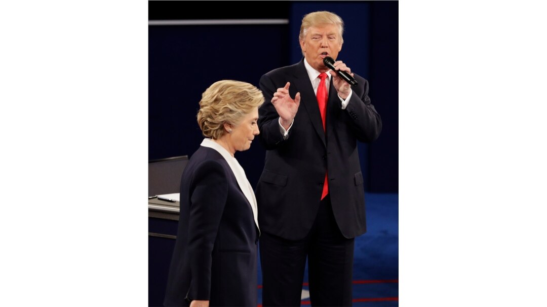 FILE - In this Oct. 9, 2016 file photo, Democratic presidential nominee Hillary Clinton walks past Republican presidential nominee Donald Trump during the second presidential debate at Washington University in St. Louis.