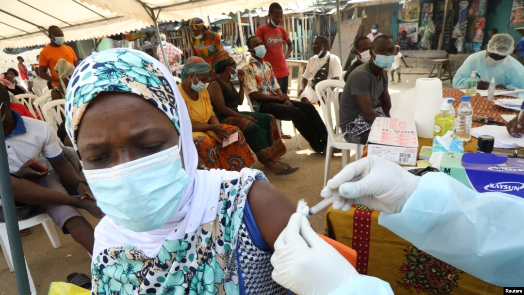 FILE - A woman receives a vaccine to protect against Ebola during a vaccination drive in the Alakro neighborhood of in Abidjan, Ivory Coast, Aug. 17, 2021. 