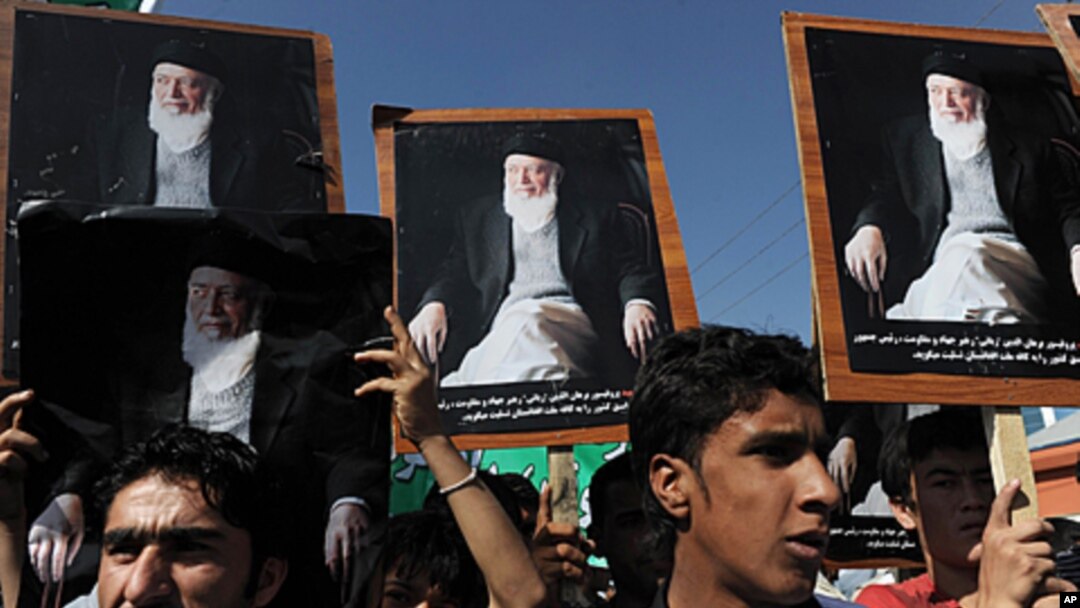Supporters of the slain former Afghan president Burhanuddin Rabbani shout slogans and hold up his portrait during a protest against the Taliban and Pakistan in Kabul, September 27, 2011.