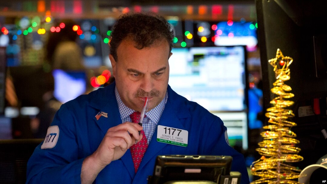 FILE - Gerard Farco follows stock prices at the New York Stock Exchange in New York, Dec. 21, 2016. 