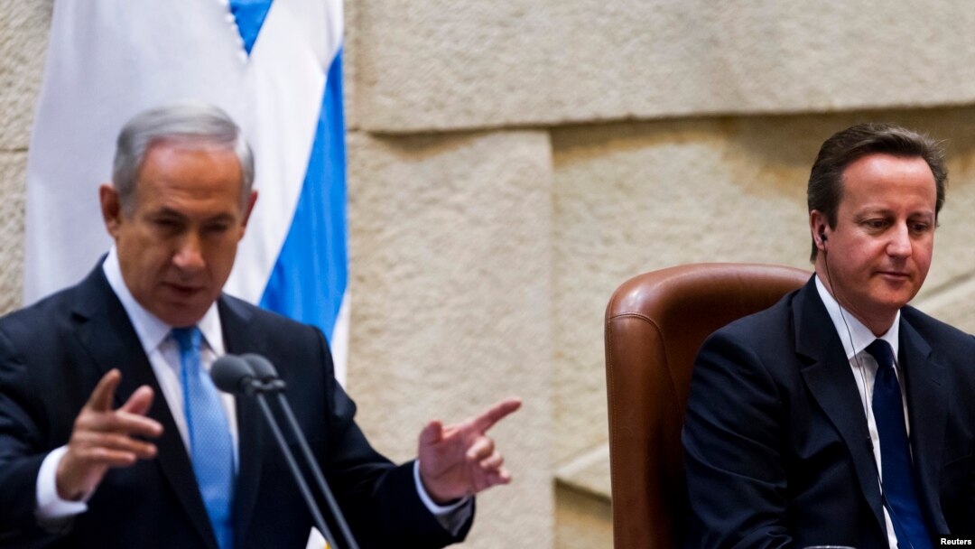 British Prime Minister David Cameron (R) listens as Israel's Prime Minister Benjamin Netanyahu delivers a speech at the Knesset, Israel's parliament, in Jerusalem, March 12, 2014.