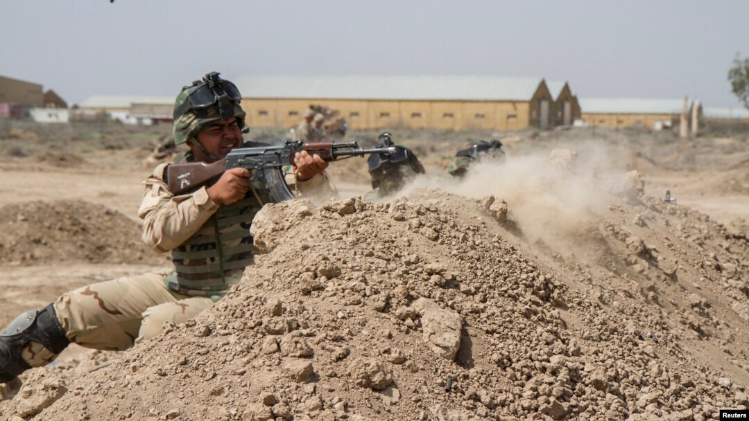 FILE - Iraqi soldiers train with members of the U.S. Army 3rd Brigade Combat Team, 82nd Airborne Division, at Camp Taji, Iraq, in this U.S. Army photo released June 2, 2015. 
