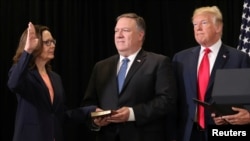Gina Haspel is sworn in as the new U.S. CIA director as Secretary of State Mike Pompeo holds the bible and President Donald Trump looks on during ceremonies at the headquarters of the Central Intelligence Agency in Langley, Virginia, May 21, 2018.