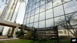 FILE - A marquee of the Arango Orillac Building lists the Mossack Fonseca law firm in Panama City, April 3, 2016. Four men have been charged in what prosecutors described as an "intercontinental money laundering scheme'' involving the global law firm.