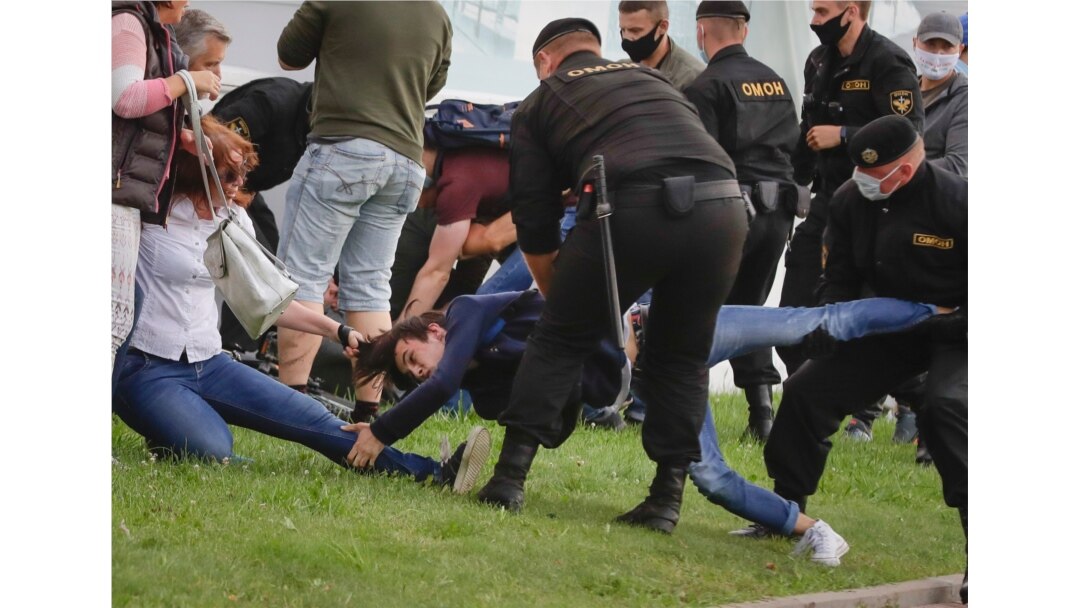 Police officers detain protesters during a rally against the removal of opposition candidates from the presidential elections in Minsk, Belarus, Tuesday, July 14, 2020.