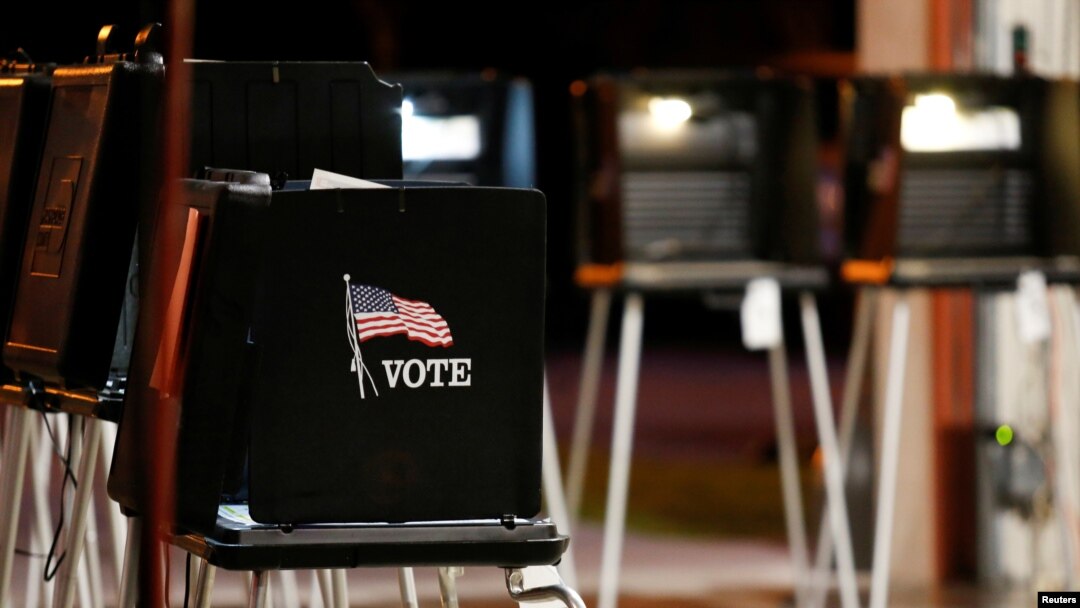 FILE - A voting booth is seen at a polling center inside a fire station during the Democratic presidential primary election in Miami, Florida, March 17, 2020. 