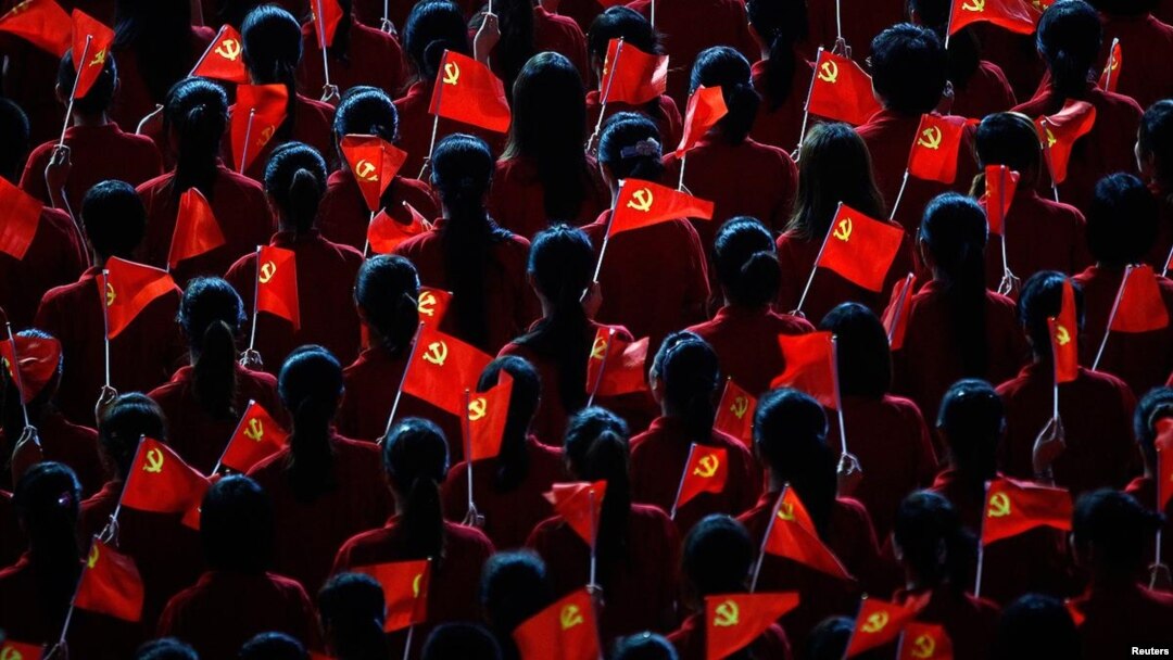 Performers hold flags of the Communist Party of China during an event to celebrate the 90th anniversary of the founding of the party, at the Mercedes-Benz Arena in Shanghai, on June 30, 2011. (Reuters/Carlos Barria)