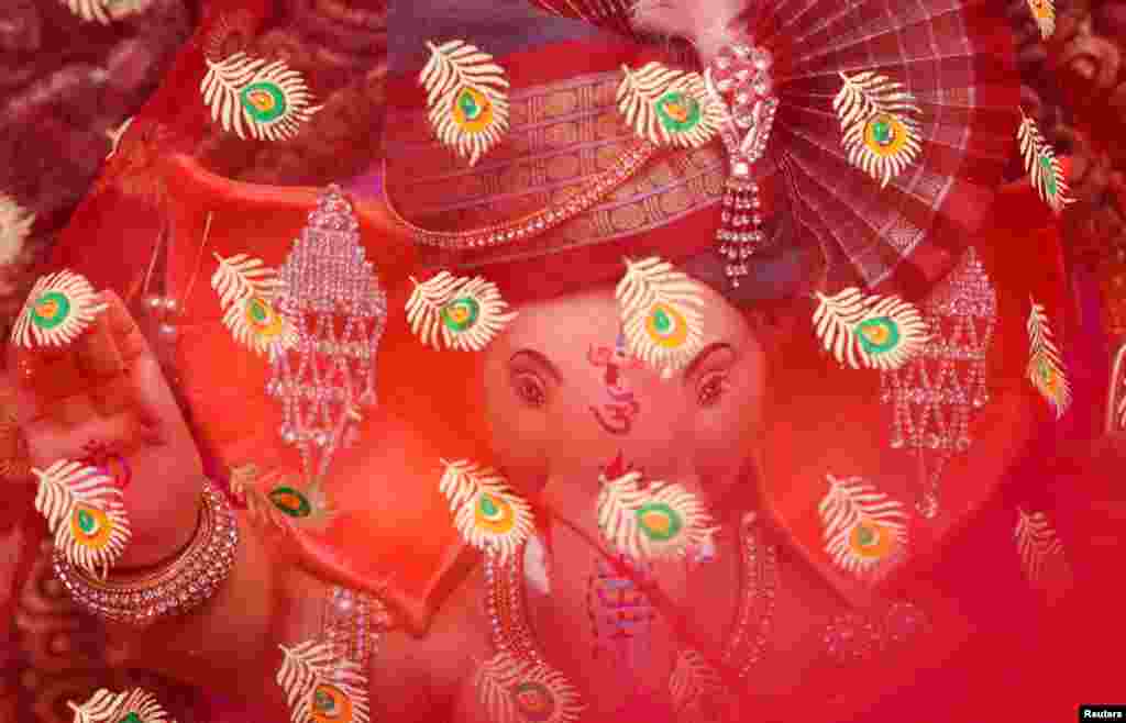 An idol of the Hindu god Ganesh is seen covered with a cloth during the start of the 10-day Ganesh Chaturthi festival in Mumbai, India.