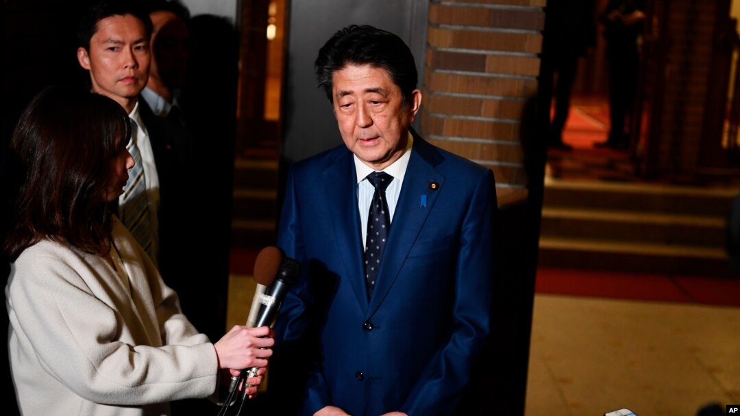 Japan's Prime Minister Shinzo Abe talks to journalists in front of the prime minister's residence in Tokyo, March 24, 2020. 