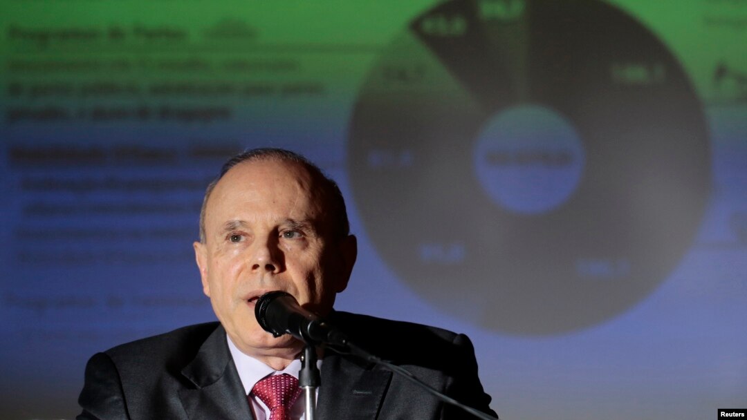 FILE - Brazil's Finance Minister Guido Mantega speaks during the announcement of cuts in the Federal Budget, at the Finance Ministry in Brasilia, Feb. 20, 2014. 
