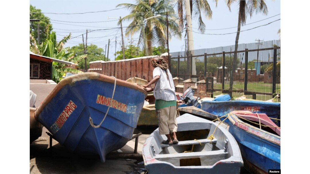 A fisherman checks a boat that was pulled from the water ahead of the arrival of Hurricane Beryl, in Port Royal, Jamaica, on July 2, 2024.
