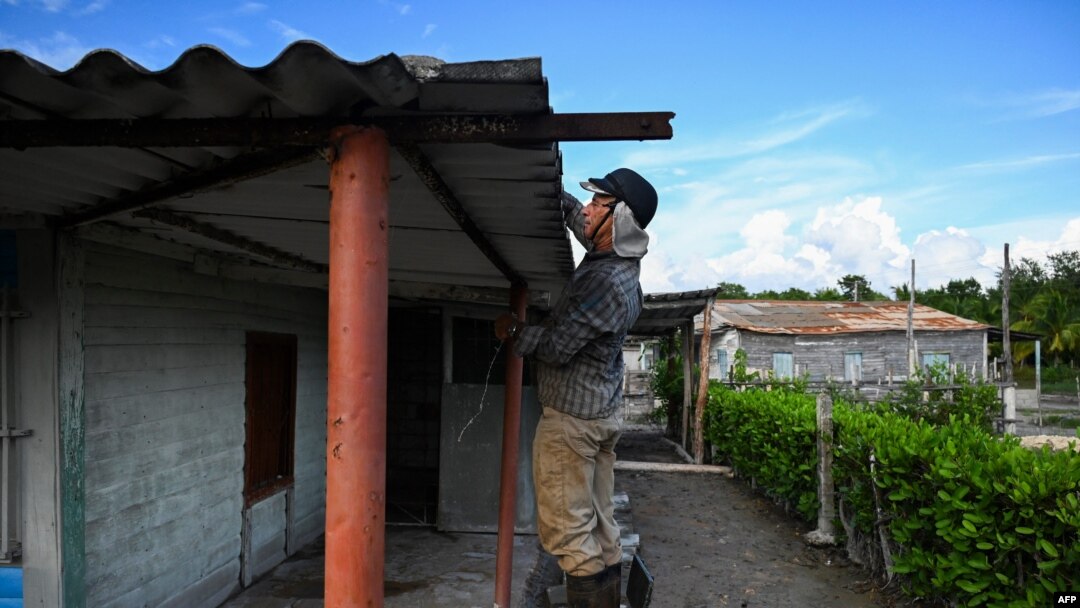A man secures the roof of his house ahead of the arrival of then-Tropical Storm Rafael in Guanimar, Artemisa province, Cuba on Nov. 5, 2024.