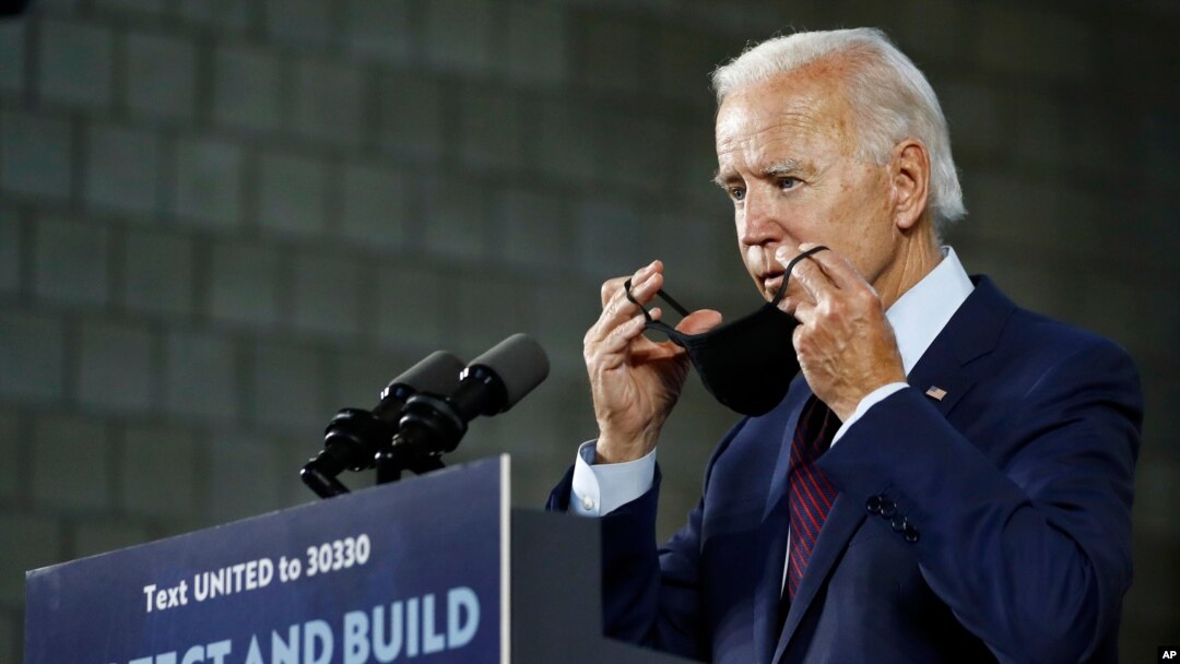 FILE - Democratic presidential candidate former Vice President Joe Biden puts on a face mask after speaking at an event in Lancaster, Pennsylvania, June 25, 2020.