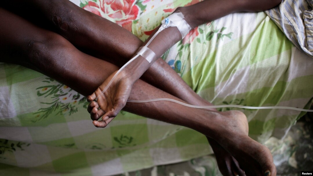 FILE - A boy rests his arm on his mother's legs as he receives treatment for cholera after Hurricane Matthew in the Hospital of Les Anglais, Haiti, Oct. 10, 2016.