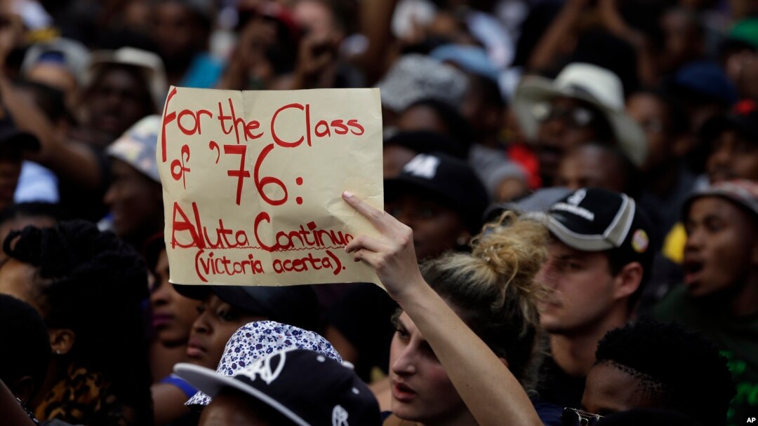 A student holds a placard during their protest against university tuition hikes outside the ruling party African National Congress (ANC) headquarters in Johannesburg, South Africa, Thursday, Oct. 22, 2015. 
