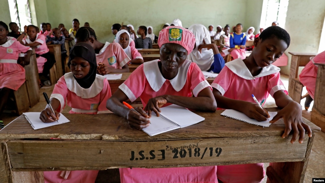 Shade Ajayi, 50, takes notes during class at Ilorin Grammar School in Ilorin, Kwara state, March 25, 2021. R
